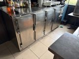 a stainless steel counter with bottles on top of it