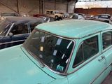many old cars parked in a garage next to each other