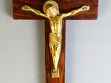 wooden crucif with a gold jesus on the cross
