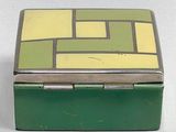 a green box with a yellow and yellow design on it