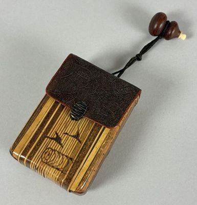 a small wooden box with a wooden bead on top of it