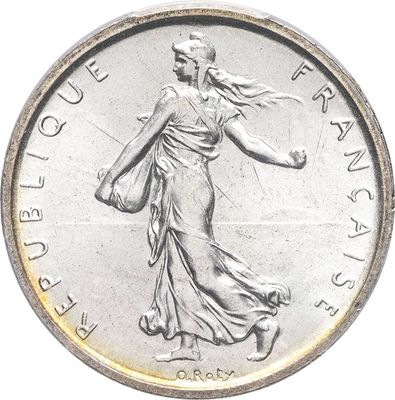 an image of a silver coin with a woman walking on it