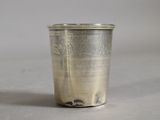 a silver cup that is sitting on a table