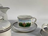 three cups and saucers sitting on a white table