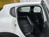 a white car with the door open and the seat down