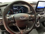 the interior of a car with a steering wheel and a tablet on the dashboard