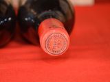 two bottles of wine sitting next to each other on a table
