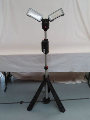 a light that is on a tripod in front of a white backdrop