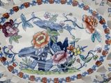a plate with a bird on it sitting on a table