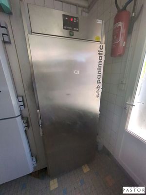 a stainless steel refrigerator in a kitchen with a window