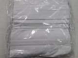 a bag of folded white napkins on a table