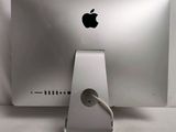 an apple computer with a charging cable attached to it