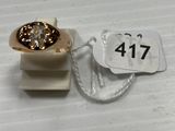 a gold ring with a diamond on top of it