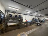 an image of a factory with a conveyor belt in the middle of it