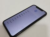 the back of a black iphone with the screen open on a white table