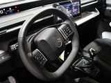 the interior of a car with a steering wheel and dashboard controls