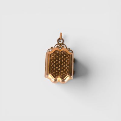 a small gold locke with a flower design on it