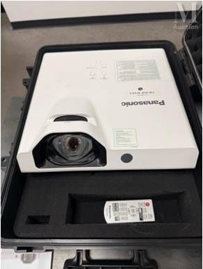 a box with a projector and a remote in it