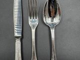 a knife, fork and spoon sitting on a table