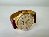 a watch that is sitting on a white surface