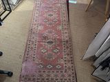 a long rug on the floor in a room