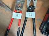 two pliers and a pair of pliers next to a tool box