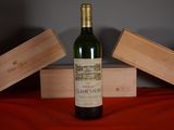 a bottle of wine sitting on a table next to two wooden boxes