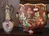 two vases sitting on a shelf next to a painting