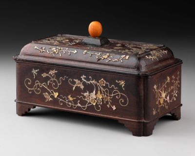 a wooden box with a orange on top of it