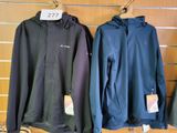 two jackets hanging on the wall in a store