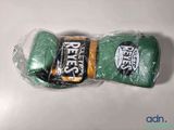a pair of boxing gloves wrapped in plastic on a table