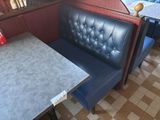 a booth with a table and two chairs in it