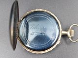 a close up of a pocket watch with a key in it