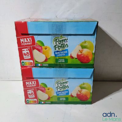 two boxes of pom poms are stacked on top of each other