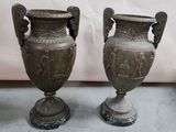 two vases that are sitting next to each other on the floor