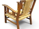 wooden chair with woven seat and arm rest on a white background