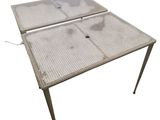 an image of a metal table with a metal mesh top