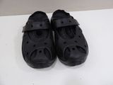 a pair of black shoes that are on a table
