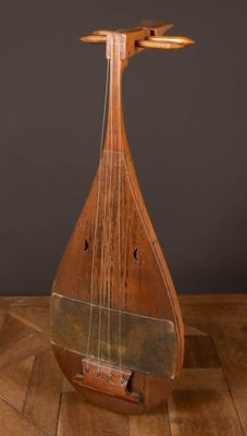 an old wooden instrument sitting on top of a hard wood floor