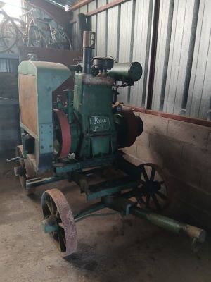 a small tractor that is sitting in a barn