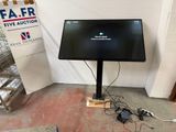 a flat screen tv sitting on a stand in a room