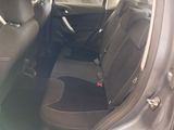 the interior of a car with a black seat cover and a steering wheel