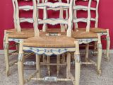 four chairs sitting next to each other in a room