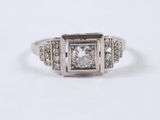 a close up of a ring with a diamond in the center
