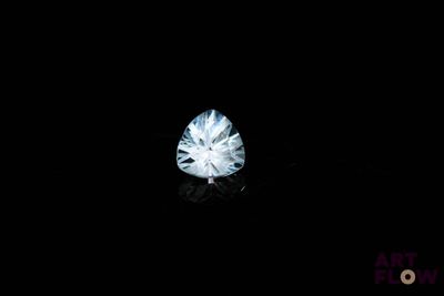 a close up of a white diamond on a black surface