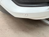 a close up of the front bumper of a white car