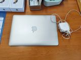 a laptop computer sitting on a desk next to a mouse and other items