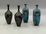 three vases are sitting side by side on a white surface