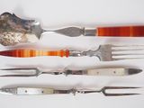 five different types of knives and forks on a white surface