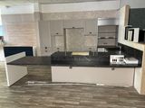 a kitchen with a black counter top and white cabinets